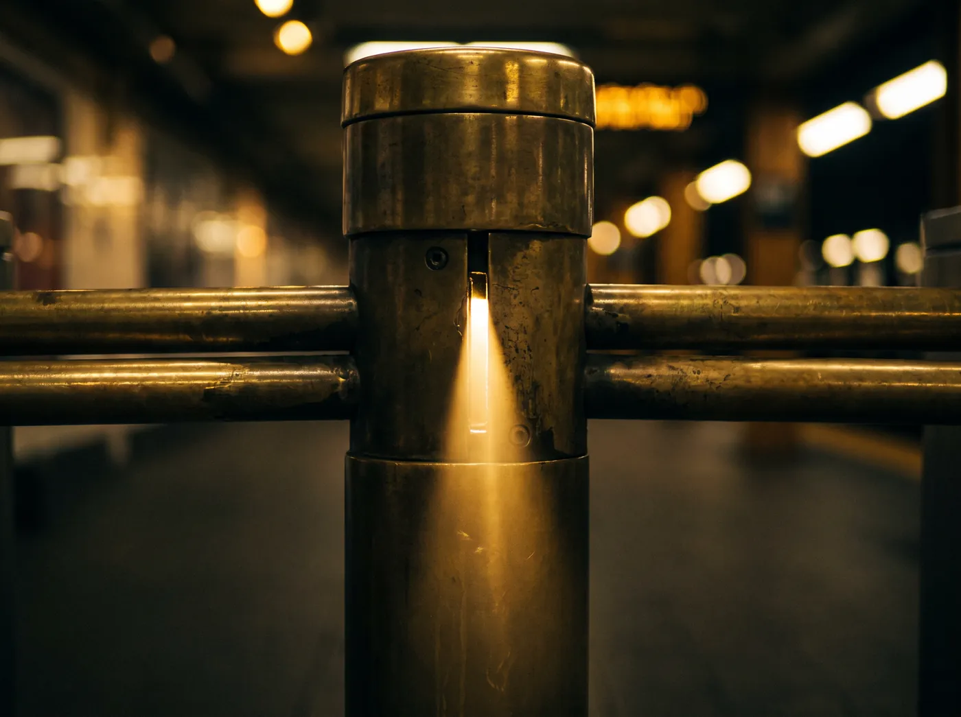 A brass turnstile with light leaking through, about to open